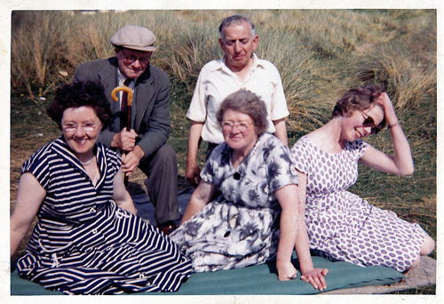 Enjoying a day on the Enniscrone beach. Dad is wearing a cap and Joan has a hand to her hair.1965